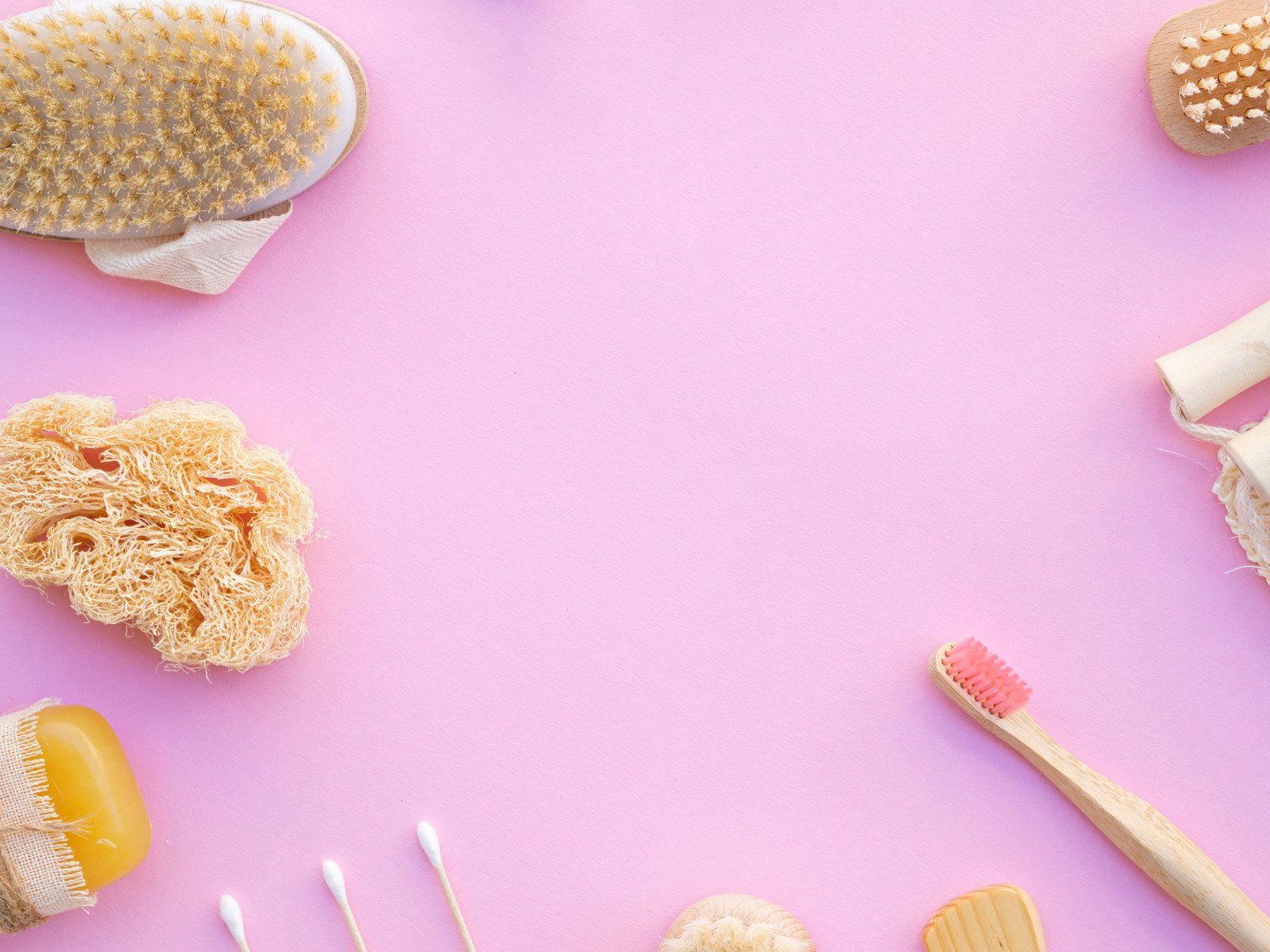 top-view-frame-with-wooden-items-pink-background